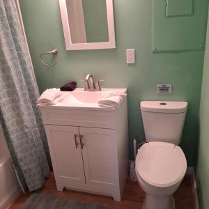 a bathroom with a white sink and a toilet at Little Oyster Oasis in White Stone +41 photos
