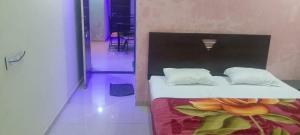 a bed with white sheets and pillows in a room at The Grand Sulochana Banglow Bhilar 101 in Mahabaleshwar +2 photos