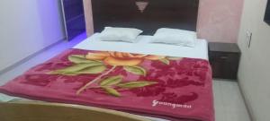 a bed in a room with a red blanket on it at The Grand Sulochana Banglow Bhilar 101 in Mahabaleshwar