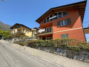 a orange building on the side of a street at Dolce Vita in Tremezzo