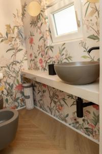 a bathroom with a sink and floral wallpaper at La Suite del Faso in Fasano