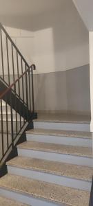 a set of stairs in a building at Les Erables Appart - 3 chambres - Spacieux et moderne avec balcon, parking et wifi in Saint-Jean-de-la-Ruelle
