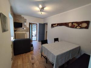 a living room with a table and a chair at Lo talapan du Bacò in Pontey