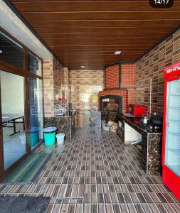 a kitchen with a brick wall and a fireplace at FAMILY vacation home in Chorwoq