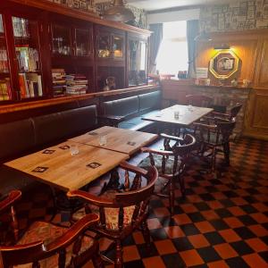 a restaurant with wooden tables and chairs in a room at The Waggon & Horses in York