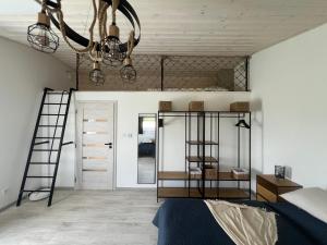 a bedroom with two bunk beds and a chandelier at Ubytovanie v objatí Liptova in Liptovská Sielnica