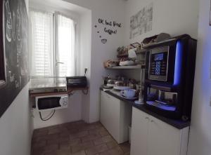 a small kitchen with a microwave and a counter at Hotel Pontenuovo in Merone