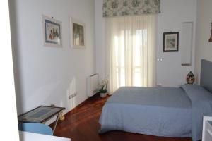 a bedroom with a bed and a table and a window at Casa MiLo in Foggia