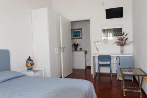 a bedroom with a bed and a table and a desk at Casa MiLo in Foggia