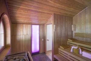 a room with a sauna with a purple light in it at MANNI das Hotel in Mayrhofen