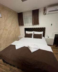 Postel nebo postele na pokoji v ubytování Sobe i Apartmani Casa Mia