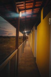 a hallway of a building with the sunset in the background at Pousada encanto do sol in Búzios +2 photos
