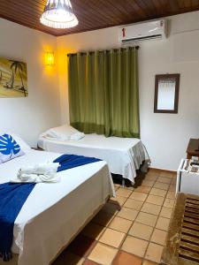 Cama o camas de una habitación en Pousada Arraial Lua Crescente