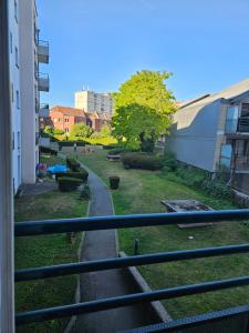 a view of a park from a balcony of a building at Charmant appartement T2 parc JB Lebas in Lille