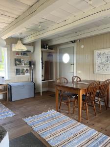 a dining room with a wooden table and chairs at Brygghuset in Linköping
