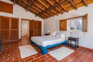 een slaapkamer met een groot bed en een raam bij Casa da Lua in Aljezur