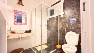 a bathroom with a shower and a toilet and a sink at Pousada Blue Ocean in Itacaré +35 photos