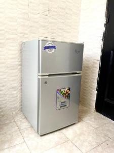 a refrigerator is sitting in a room at Appartement Yoff Oasis in Dakar