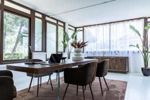 a dining room with a table with a laptop on it at Residence Il Boschetto - Villa Con Piscina in Grosseto