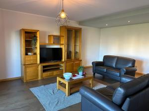 a living room with a couch and a television at Apartamento Braguinha in Bragança