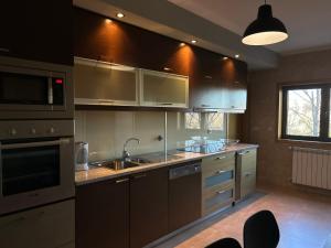 a kitchen with a sink and a stove top oven at Apartamento Braguinha in Bragança