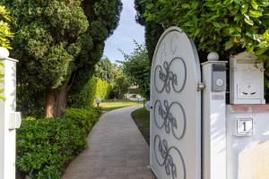 a couple of doors that are next to a sidewalk at Residence Il Boschetto - Villa Con Piscina in Grosseto