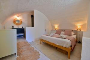 a bedroom with a large bed in a white room at Le Clos Saint-Sif, 4 BR, air conditioning, pool in Saint-Siffret +35 photos