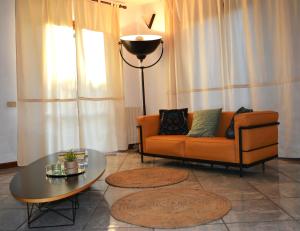 a living room with a couch and a table at Villa Luisa Design in Colle Val D'Elsa +44 photos