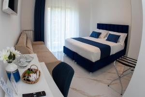 una habitación de hotel con una cama y un sofá en BeB Le Sirene, en Sorrento