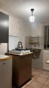 a kitchen with a stove with a tea kettle on it at tata's house in K'obulet'i