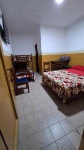 a bedroom with a bed and a dresser in it at Hospedaje Artigas in Corrientes
