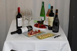 a table topped with bottles of wine and wine glasses at Casa Marisa in San Asensio