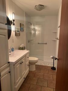 a bathroom with a sink and a toilet and a shower at Lake Wisconsin Resort in Harmony Grove +103 photos