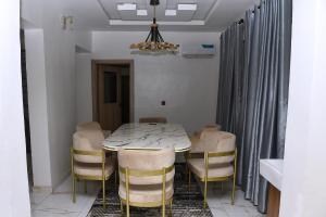 a dining room with a table and chairs at 2 bedroom duplex apartment in Ibadan