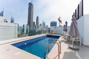 a swimming pool on top of a building with a city skyline at Luxury Hostel Bedspace in Downtown Near Emirates Towers Metro in Dubai