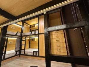 a view of a room with a bunk bed and windows at Luxury Hostel Bedspace in Downtown Near Emirates Towers Metro in Dubai +33 photos