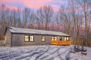 a house with a garage in the snow at Buckingham Woods I Hocking Hills in Logan