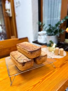 three loaves of bread sitting on a rack on a table at VILLA SUNNY ROSE Bed & Breakfast in Świnoujście +39 photos