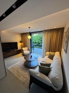 a living room with a couch and a table at Garden Hill Mitrovac na Tari in Mitrovac