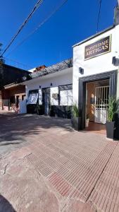 a white building with a sign on the front of it at Hospedaje Artigas in Corrientes