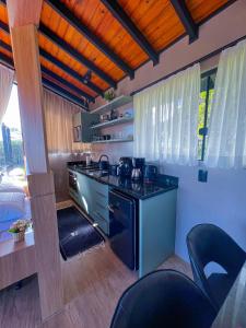 a kitchen with a stove and a counter top at Chalé Heinz in Rancho Queimado