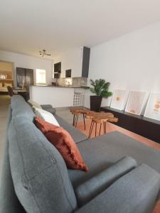 a living room with a gray couch and a table at Casa Aguadulce Puerto in Aguadulce