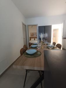 a dining room table with glasses and plates on it at Casa Aguadulce Puerto in Aguadulce