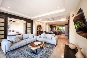 a living room with a couch and a table at Rooftop Pool & Ocean Views, Sunset BBQ in Ocotal +17 photos