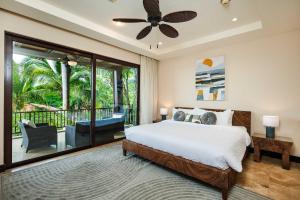 a bedroom with a large bed and a balcony at Rooftop Pool & Ocean Views, Sunset BBQ in Ocotal
