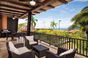 an outdoor patio with chairs and tables and the ocean at Rooftop Pool & Ocean Views, Sunset BBQ in Ocotal