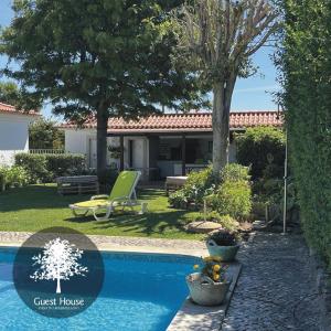 a view of a guest house with a swimming pool at Casa do Marmeleiro Guest House in Alcabideche