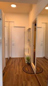 an empty hallway with a door and a plant on the floor at Monolocale Riva Lake in Valbrona