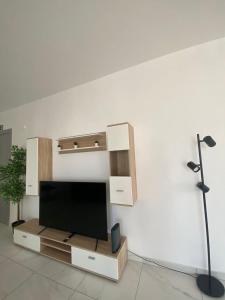 a living room with a flat screen tv on a wall at Marija Block St Julian's Apartments in Is-Swieqi