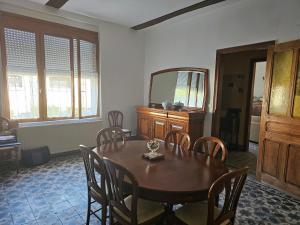 a dining room with a table and chairs and a mirror at Les Roses du Souvenir in Mailly-Maillet +15 photos